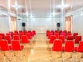 Meeting room with red chairs and white background Royalty Free Stock Photo