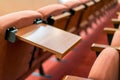 Meeting room table on the seats for convenient writing Royalty Free Stock Photo