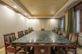 Meeting room with a wooden table and green marble with chairs Royalty Free Stock Photo