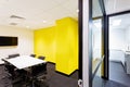 Meeting room with yellow walls hallway to kitchen Royalty Free Stock Photo