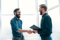 Meeting and shaking hands with business people in a bright office Royalty Free Stock Photo