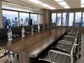 Meeting table and office chairs inside the boardroom. 3D illustration