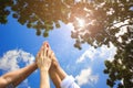 Meeting teamwork concept,Friendship,Group people with stack of hands showing unity on natural green and blue sky background Royalty Free Stock Photo