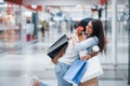 Meeting of two female friends in the mall at weekend shopping time Royalty Free Stock Photo