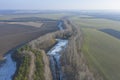 Meeting of two seasons. A combination of autumn trees and an icy river Royalty Free Stock Photo