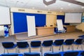 Meeting zone in the office in a loft style with white brick walls and concrete columns. Zone has a large wooden table with gray