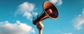 The megaphone raised high in the blue sky symbolizes a powerful message..AI generated image Royalty Free Stock Photo