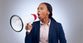 Megaphone, speech and angry business woman in studio for change, transformation or freedom on grey background. Corporate