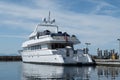 Megayacht reflecting on still waters in the marina.