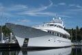 Megayacht reflecting on still waters in the marina.