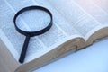 Megnifying glass on page of dictionary. Royalty Free Stock Photo