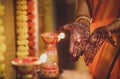Mehendi on girl& x27;s hand with beautiful composition of flowers and lamps. Indian ritual before wedding.