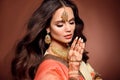 Mehendi. Portrait of beautiful indian girl in sari. Young hindu woman model with kundan golden jewelry set. Traditional Indian Royalty Free Stock Photo