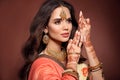 Mehendi. Portrait of beautiful indian girl in sari. Young hindu woman model with kundan golden jewelry set. Traditional Indian Royalty Free Stock Photo