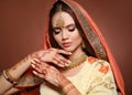 Mehndi. Portrait of beautiful indian girl in saree. Young hindu woman model with kundan golden jewelry set. Traditional Indian