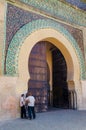Meknes, Morocco - August 21 2013: Three unidentified Moroccan men talking in front of historic Bab Mansour Gate