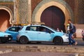 MEKNES, MOROCCO - JUNE 01, 2017: Blue petit taxi car near Bab Mansour Gate in Meknes. Meknes is one of the four Imperial cities of Royalty Free Stock Photo