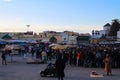 Market on El Hedim square. A crowd of people looks at street performers, a man in national clothes