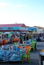 An outdoor cafe with colorful chairs on the square in El Hedim