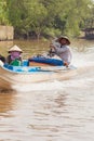 Mekong Delta, Vietnam. Vietnamese couple on the fishing motor boat