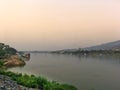 Mekong river and bridge crossing to Laos on evening with sunset and yellow sky Royalty Free Stock Photo