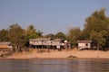Mekong River Laos from the water showing riverbank activity and boats Royalty Free Stock Photo