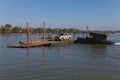 Mekong River Laos from the water showing riverbank activity and ferry boats with cars Royalty Free Stock Photo