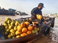 Coconut seller on barge at Mekong river floating market. Vietnamese and Asian culture and tradition.