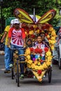 MELAKA, MALAYSIA - AUGUST 22: Trishaw rider with a decorated colorful pedicab Royalty Free Stock Photo