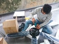 Electrical man install a ceiling fan Royalty Free Stock Photo