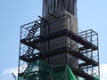 Installation of temporary scaffolding for the construction of tall concrete structures.