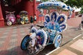 Melaka, Malaysia - March 22, 2016: Trishaw decorated with colorful flowers waiting for customer in Malacca city that designated U