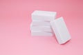 Melamine sponge stack on pink background