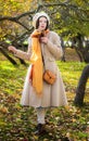 Melancholic girl in a light coat and beret in the park