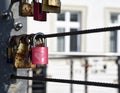 A melancholic photo of a red lock hanging from a bridge representing Love and secrets