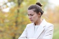 Melancholic sad woman looking down in a park in winter Royalty Free Stock Photo