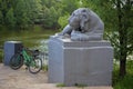 Melancholic stone lion guards a parked bike