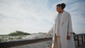 Melancholic woman walking beach on autumn weekend. Upset black hair female doubt Royalty Free Stock Photo