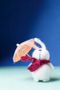 Melancholy concept. Rabbit character with umbrella. Windy rainy day. Person with scarf Royalty Free Stock Photo