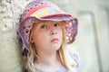 Melancholy pretty young blonde girl making eye contact with camera. Shallow depth of field with copy space Royalty Free Stock Photo