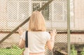 Melancholy woman touches the hand of an iron chain-link Royalty Free Stock Photo