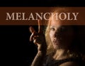 Melancholy written on virtual screen. hand of young woman melancholy and sad at the window in the rain Royalty Free Stock Photo