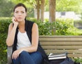 Melancholy Young Adult Woman Sitting on Bench Next Royalty Free Stock Photo