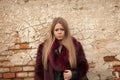 Melancholy young girl with red fur coat Royalty Free Stock Photo