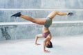 Melanesian athlete girl doing split upside down in headstand pose Royalty Free Stock Photo