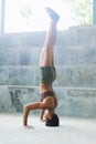 Melanesian pacific islander athlete girl with afro performing exercising routines headstand