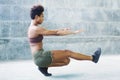 Melanesian pacific islander athlete girl with afro performing exercising routines sitting plank Royalty Free Stock Photo