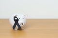 Melanoma and skin May cancer month, Black Ribbon with Piggy Bank for support illness life. Health, Donation, Charity, Campaign, Royalty Free Stock Photo