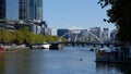 Melbourne, Australia - April 6, 2018: Rainbow bridge and Yarra river surrounded by skyscrapers