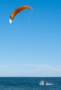 Kite surfer making splashes in water.